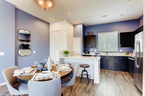 a kitchen and dining room with a table and chairs
