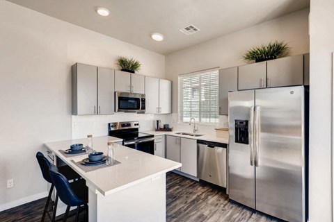 a kitchen with stainless steel appliances and a white counter top