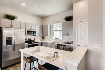 Fitted Kitchen With Island Dining at Avilla Buffalo Run, Colorado, 80022 - Photo Gallery 6