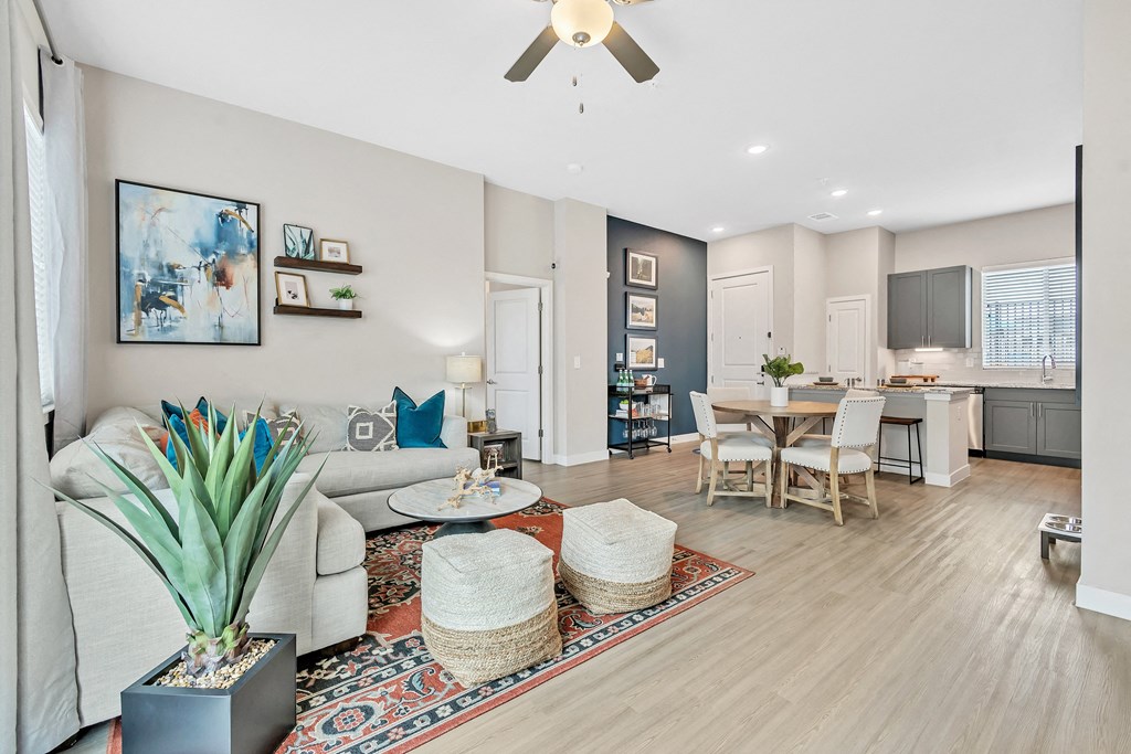 a living room and dining room with a couch and a table at Avilla Towne Center Apartments, Texas