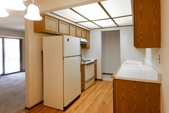 a kitchen with a refrigerator and a sink in a house