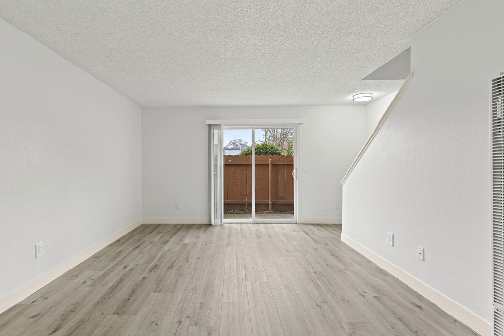 A room with a wooden floor and white walls at Stony Creek Apartments, Santa Rosa, California