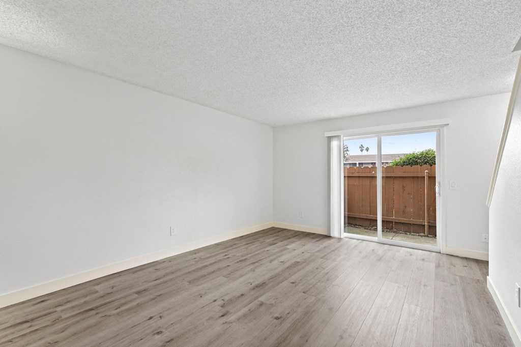 Empty room with wooden flooring and white walls  at Stony Creek Apartments, California