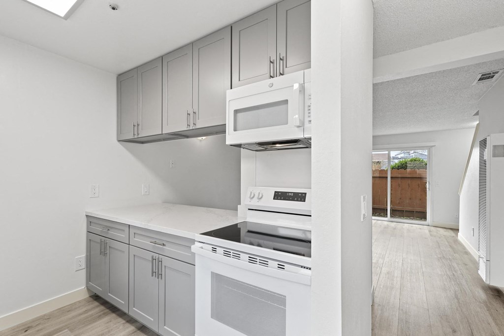 A modern kitchen with white appliances and cabinets at Stony Creek Apartments, Santa Rosa, CA