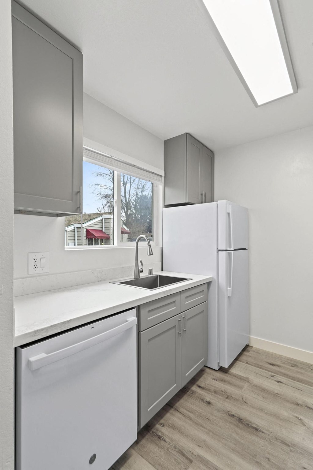 A kitchen with a white fridge and a white dishwasher at Stony Creek Apartments, Santa Rosa, CA