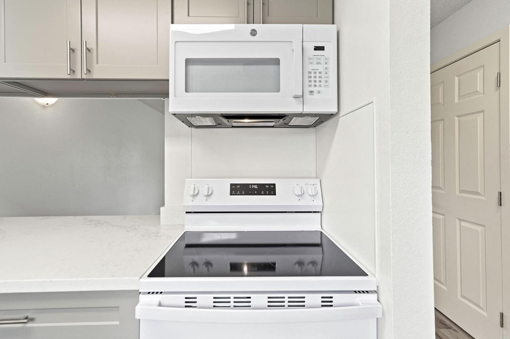 A white stove and microwave in a kitchen at Stony Creek Apartments, California