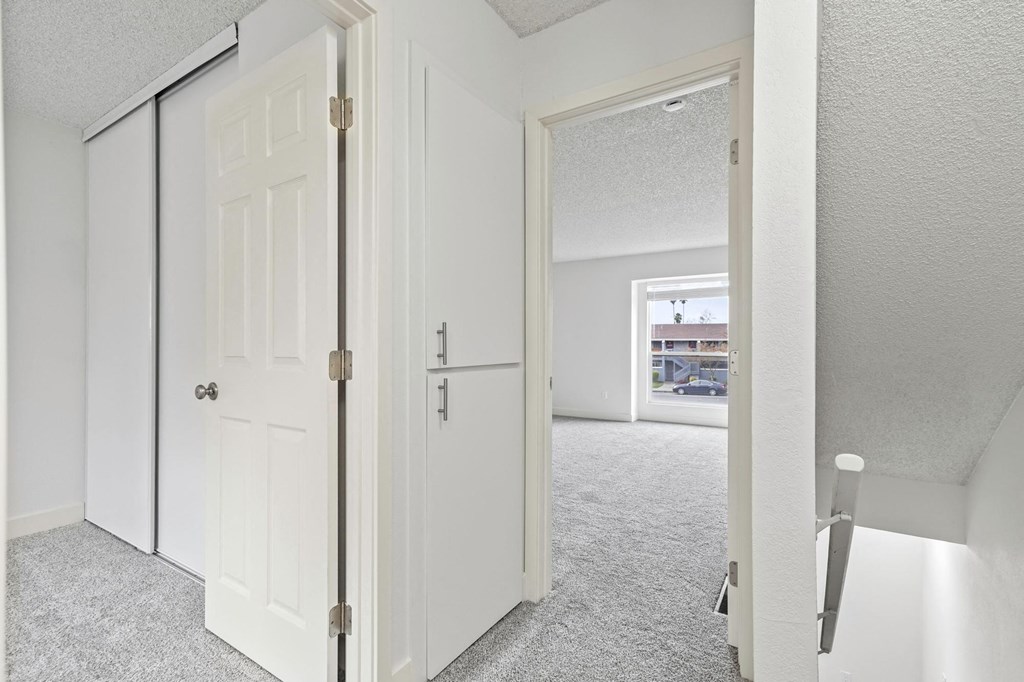 A white door with a gold handle is open at Stony Creek Apartments, Santa Rosa, CA