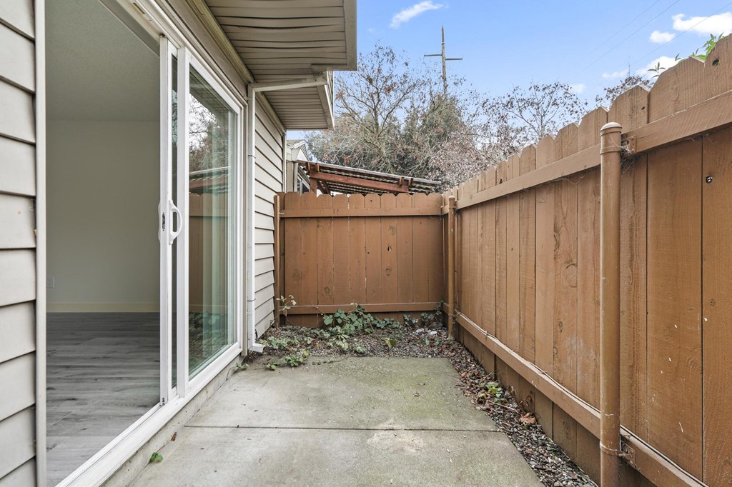 A brown wooden fence is in front of a house at Stony Creek Apartments, Santa Rosa, 95401
