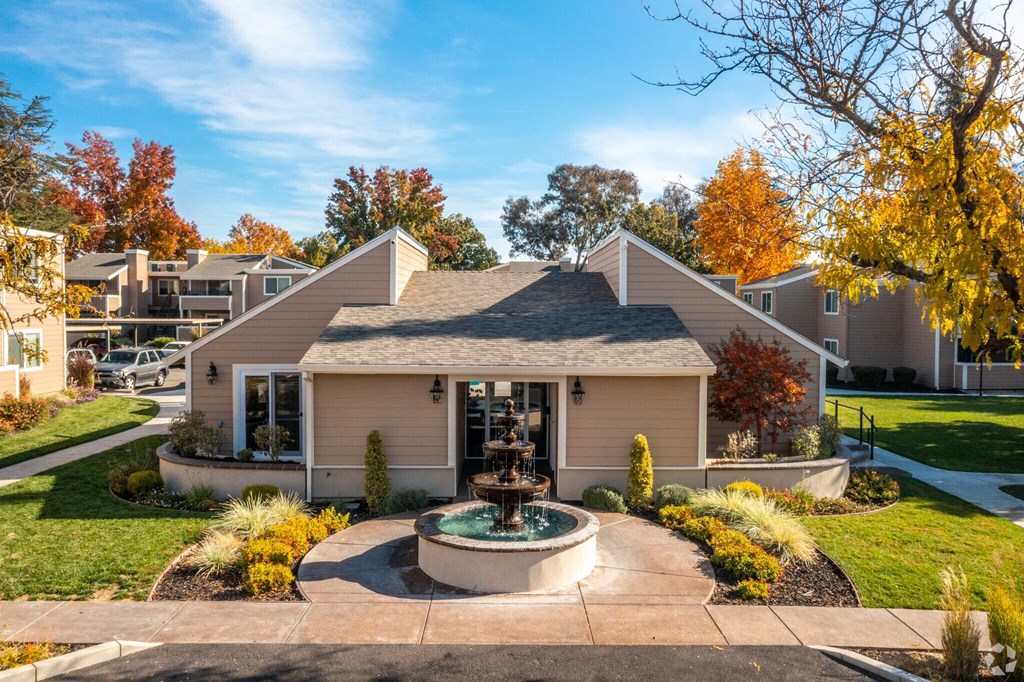 a house with a fountain in front of it