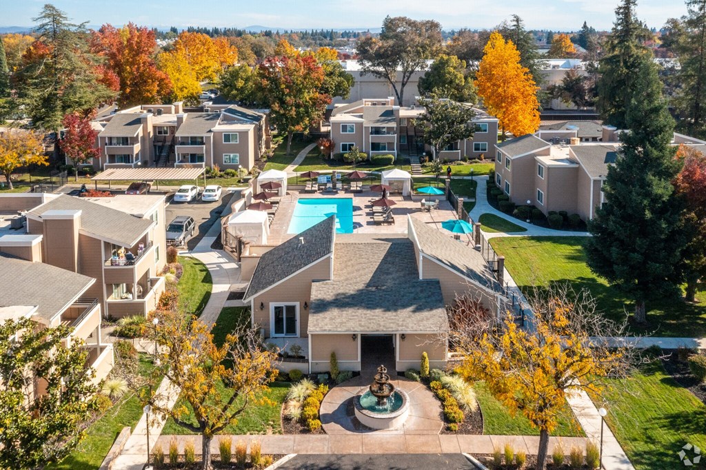 a aerial view of a neighborhood with houses and a swimming pool