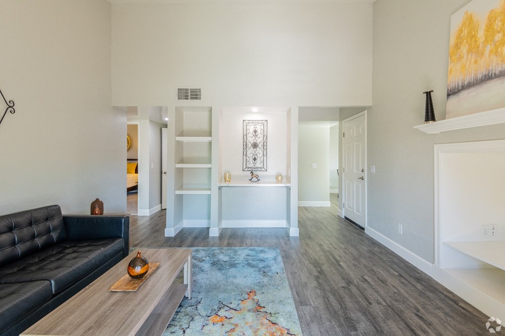 a living room with a leather couch and a rug