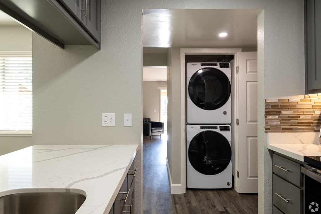 a kitchen with a washing machine and a washer and dryer in it
