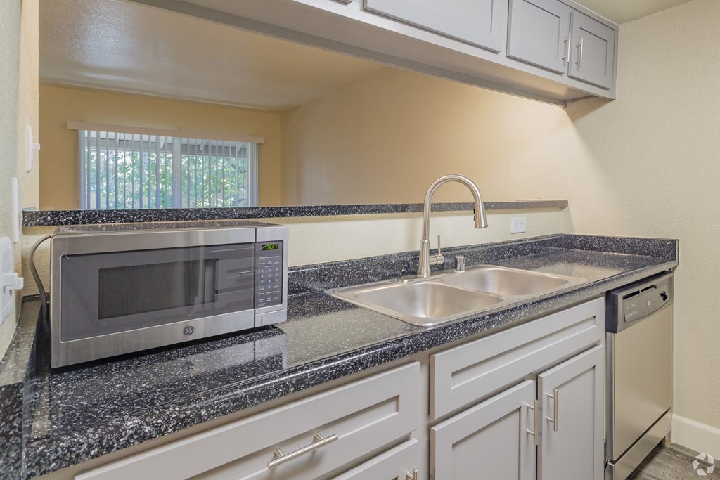 a kitchen with a sink and a microwave