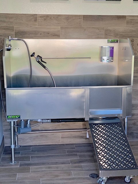 a stainless steel refrigerator in a kitchen with a step stool