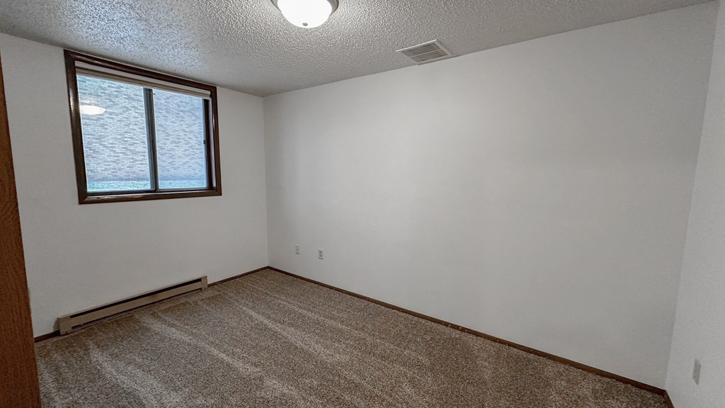 the living room of an empty house with a window