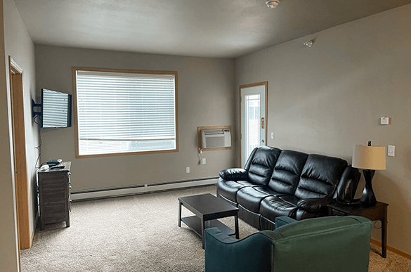 a living room with leather furniture and a window