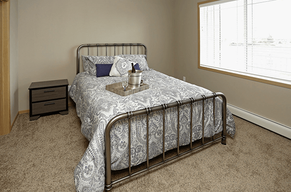 a bedroom with a bed and a window