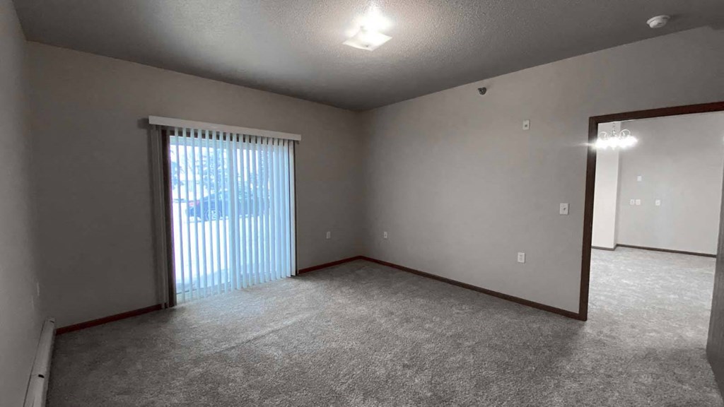 Master bedroom at Amber Crossing with large windows and view of both the bedroom and living room