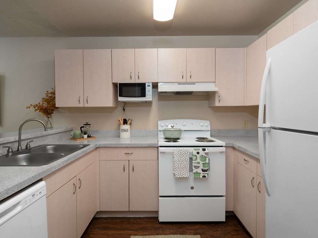a kitchen with white appliances and white cabinets