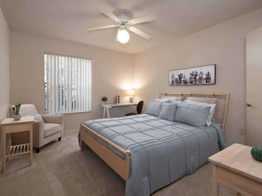 a bedroom with a large bed and a ceiling fan