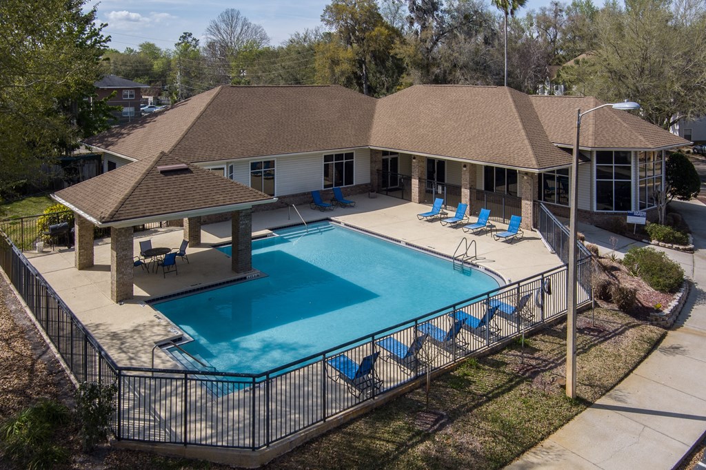 an aerial view of a swimming pool and a house with a pool