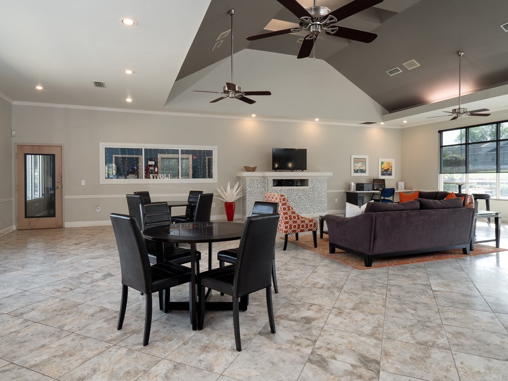 a large living room with a dining room table and chairs