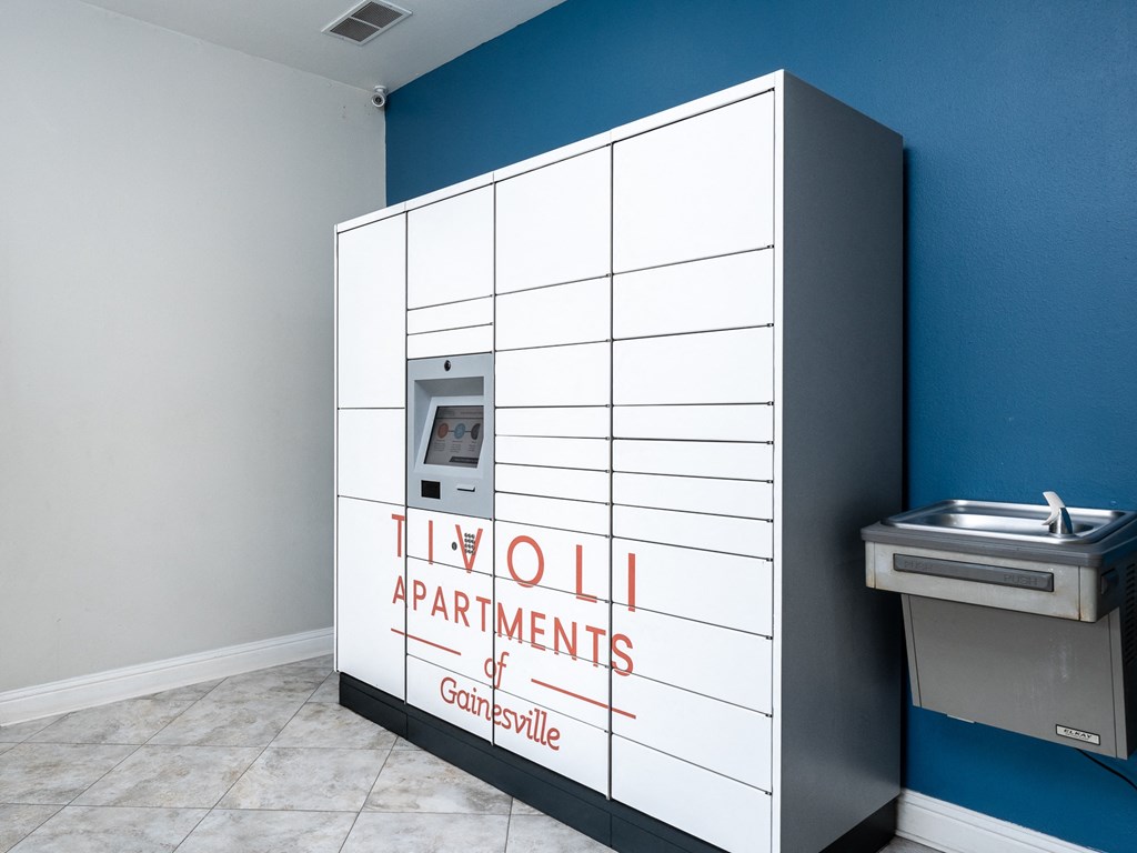 a bathroom with a tiled wall with a urinal and a sink in it