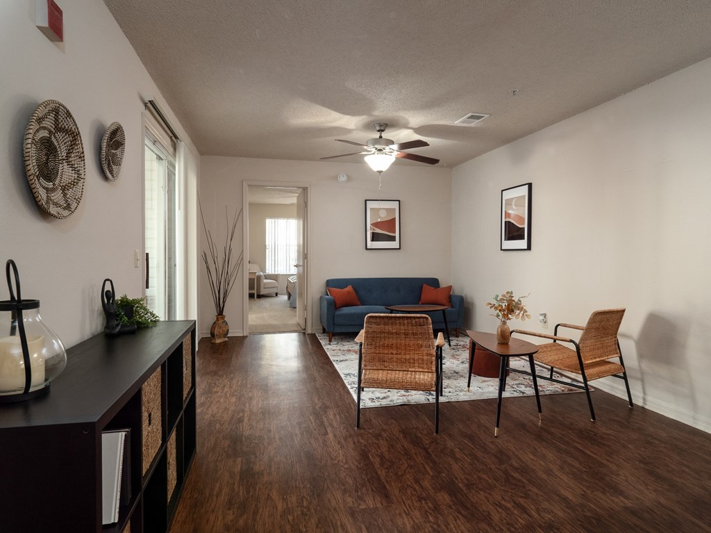 a living room with a couch and a table and a ceiling fan