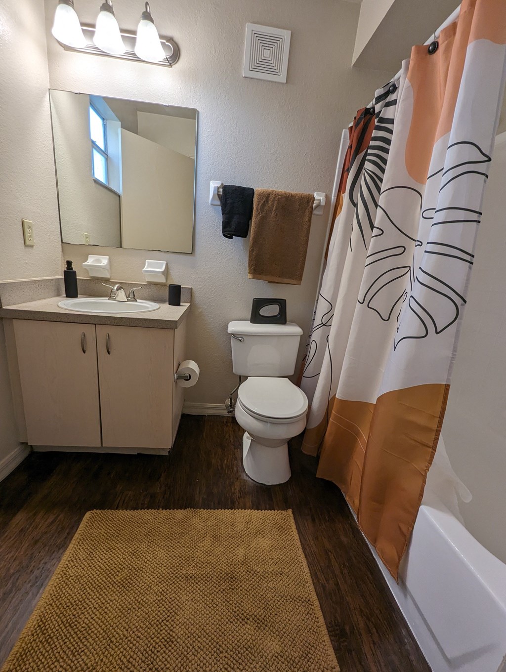 a bathroom with a toilet and a sink and a shower at Tivoli Apartments of Orlando, Oviedo, Florida