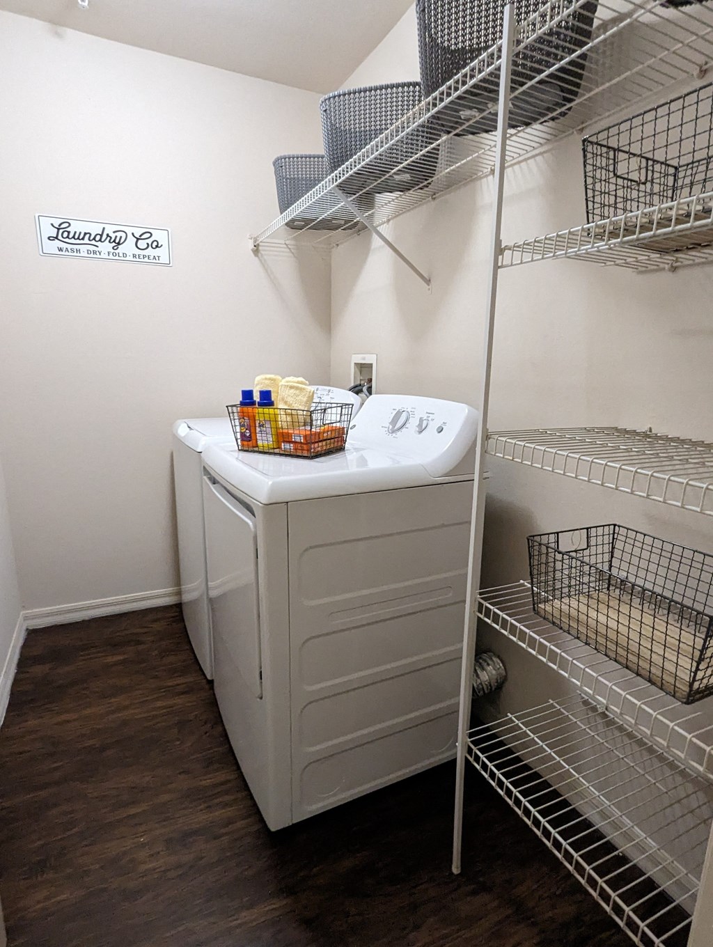 a walk in closet with a washer and dryer in it and a shelf at Tivoli Apartments of Orlando, Oviedo, 32765
