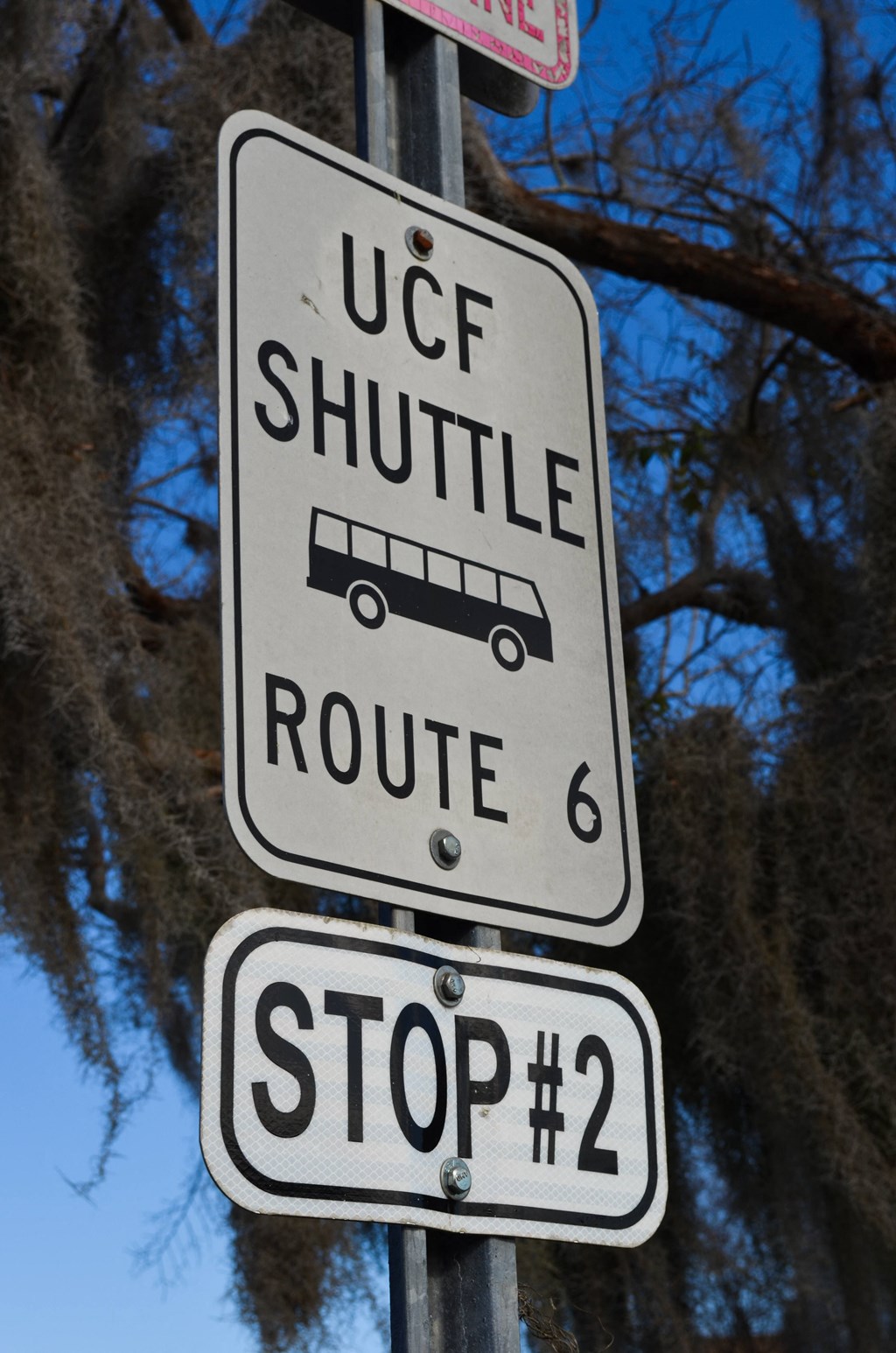 a street sign that reads shuttle route 6 and stop 2 at Tivoli Apartments of Orlando, Oviedo, Florida, 32765