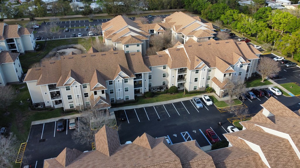 an aerial view of an apartment complex with cars parked in a parking lot at Tivoli Apartments of Orlando, Oviedo, FL, 32765