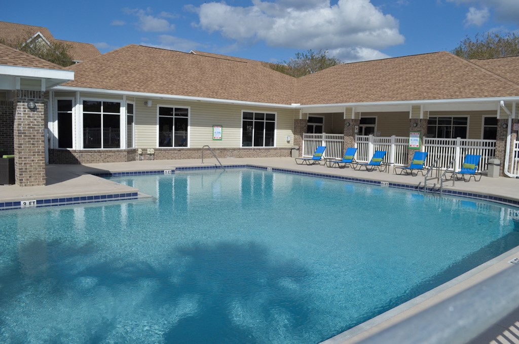 a large swimming pool in front of a building with a resort style pool at Tivoli Apartments of Orlando, Oviedo, Florida