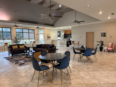 A modern dining room with a round table and chairs at Tivoli Apartments, Gainesville, 32608