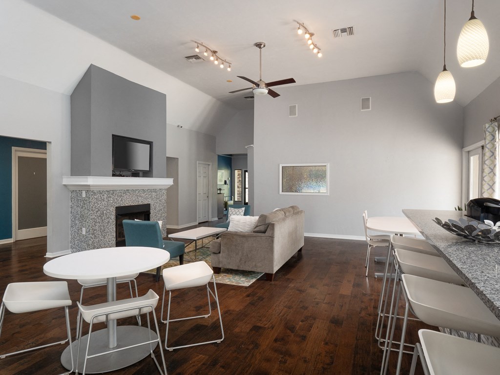 The clubhouse with a dining room and a kitchen with stools at Stoneridge Apartments, Gainesville, FL
