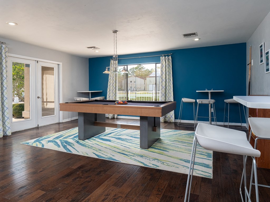 a game room with a pool table and a bar at Stoneridge Apartments, Gainesville, 32608