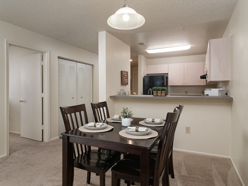 an open kitchen and dining room with a table and chairs at Stoneridge Apartments, Gainesville, Florida, 32608