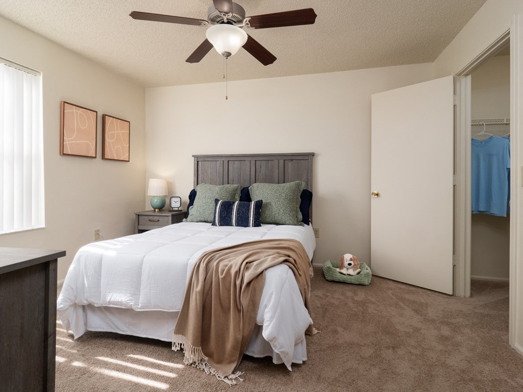 a bedroom with a bed and a ceiling fan at Stoneridge Apartments, Gainesville, Florida
