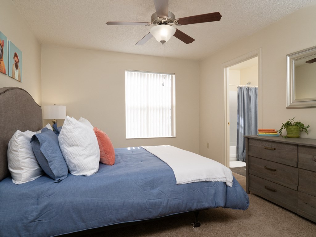 a bedroom with a large bed and a ceiling fan at Stoneridge Apartments, Gainesville, 32608