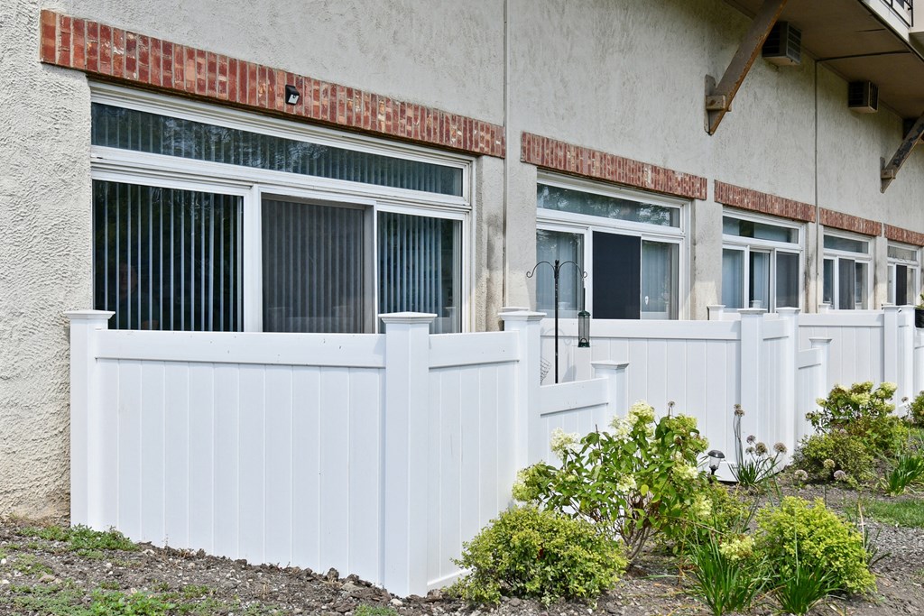 a white fence in front of a white buildingat Fox Run Apartments, Illinois