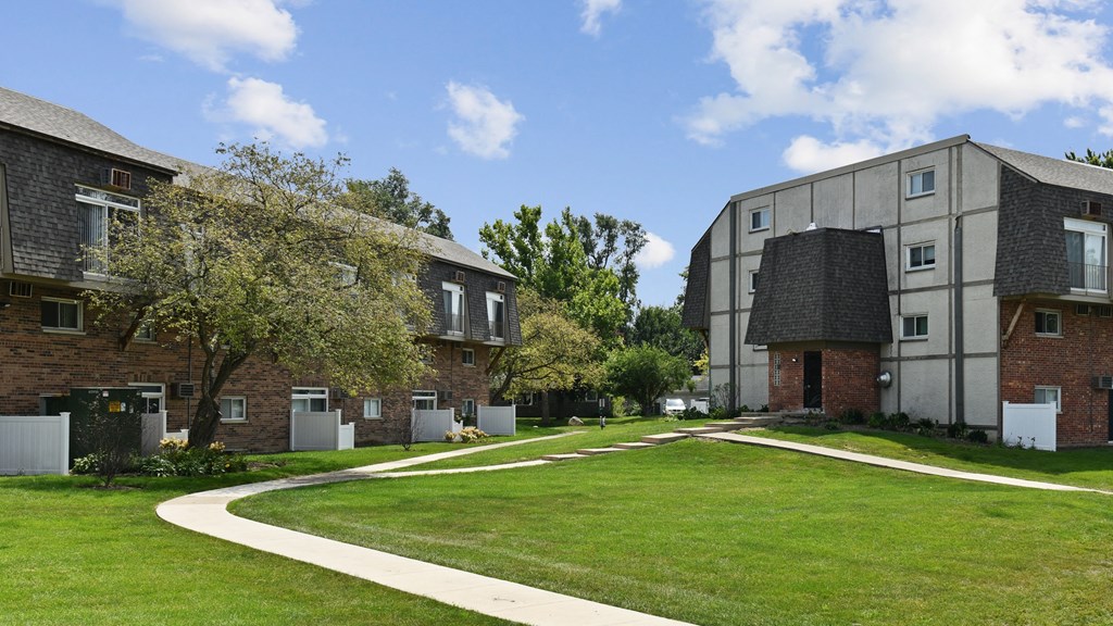 a green lawn between two apartment buildings on a sunny dayat Fox Run Apartments, St. Charles, IL, 60174