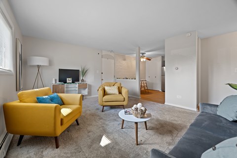 A living room with a yellow chair and a grey couch.