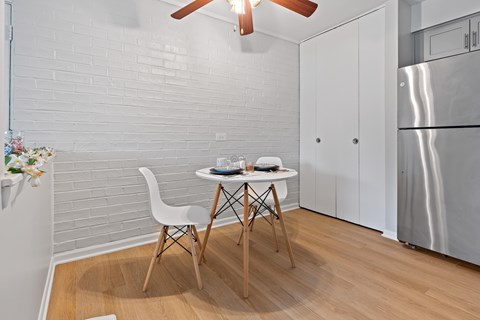 A small dining area with a white table and chairs.