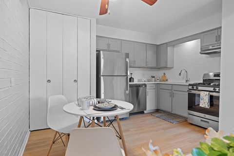 A modern kitchen with a dining table set for two.