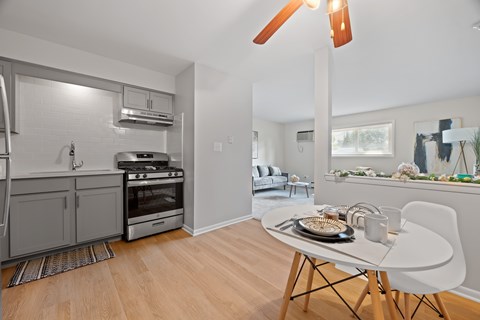 A modern kitchen with a dining table and chairs.