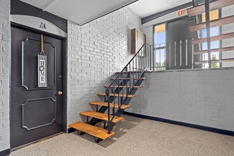 A black door with a sign that says "HOME" on it.