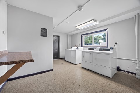 A white reception area with a desk and a window.