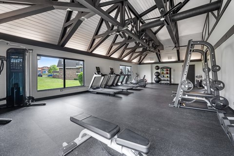 A spacious home gym with a variety of equipment.