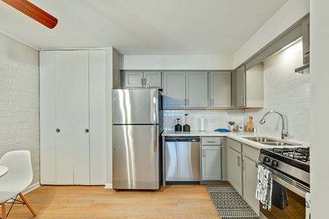 Bright and updated kitchen with new stainless steel appliances including a fridge, dishwasher machine, stove, and many more at Aspen Ridge Apartments in West Chicago Illinois 60185