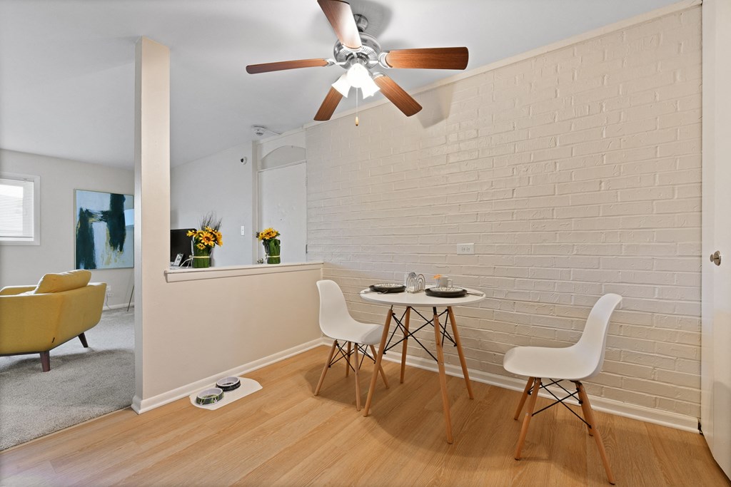 a dining room with a table and chairs and a ceiling fan a dining room with a table and chairs and a ceiling fan at Aspen Ridge Apartments, West Chicago, IL
